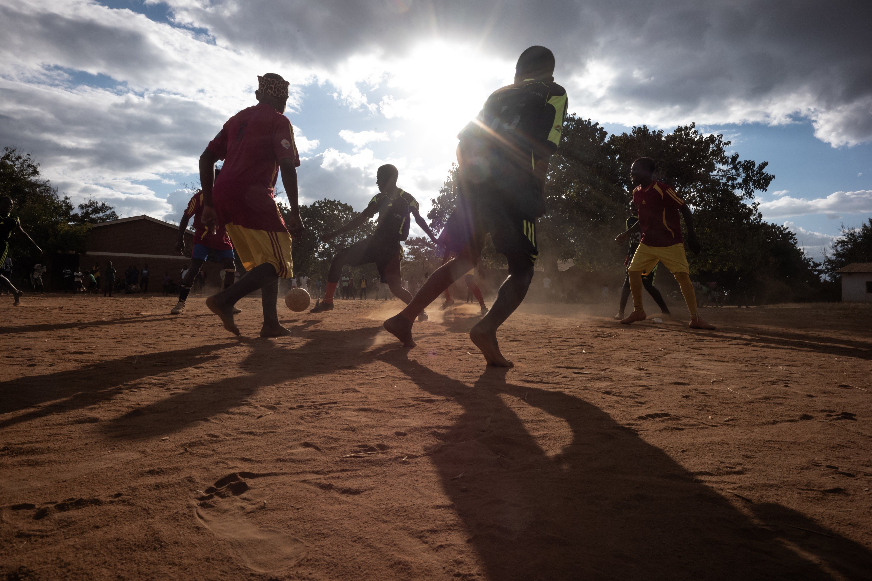 We bring boys and girls together to play football to encourage gender equity.